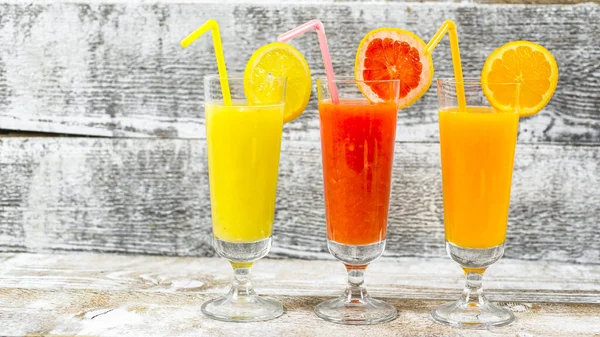 freshly squeezed juices on wooden background