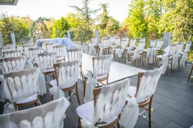 Gün batımında terasta çiçeklerle güzel bir düğün töreni.