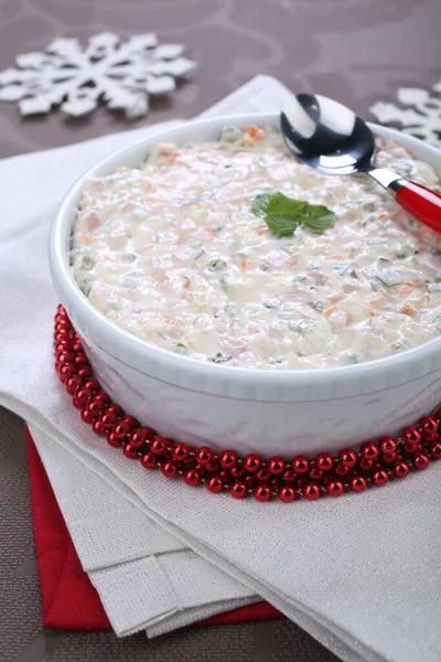 Russian traditional salad olivie. Salad with chopped vegetables and mayonnaise. Russian salad