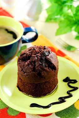 Fresh baked delicious muffins and cup of coffee on table.