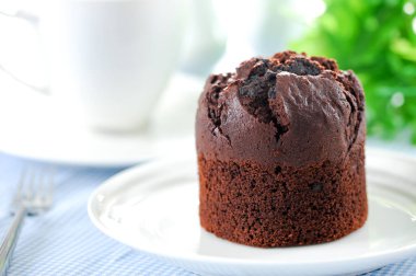 Fresh baked delicious muffins and cup of coffee on table.