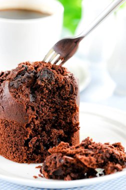 Fresh baked delicious muffins and cup of coffee on table.