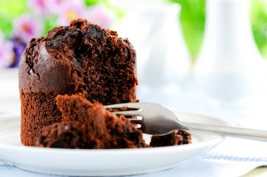 Fresh baked delicious muffins and cup of coffee on table.