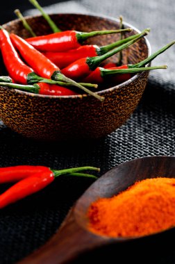 Cayenne pepper with red chili on black background.