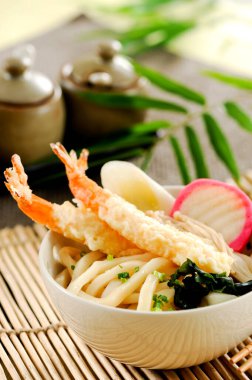 Udon noodle soup topped with shrimp tempura.Tradition japanese food