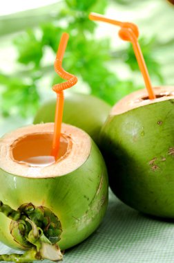 Freshly cut green tropical coconut fruit ready to drink.