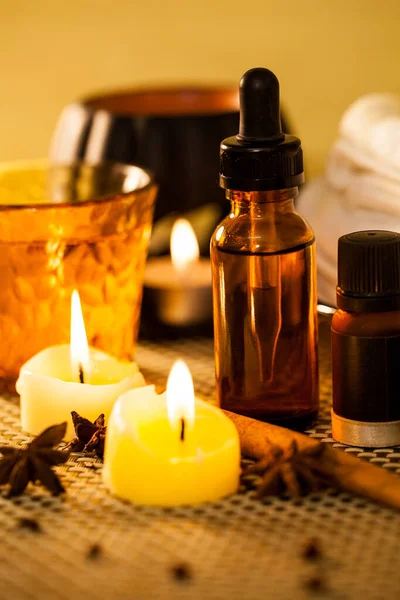 Spa aromatherapy with candle and spa set to relax on wooden background.