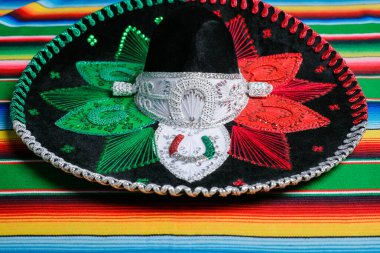 Mariachi hat with the colors of the Mexican flag on a colorful serape. Mexican sombrero.