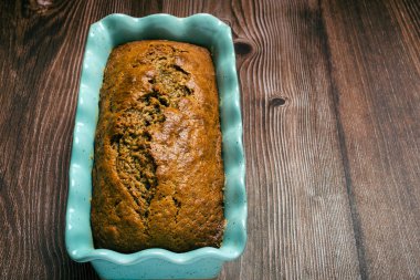 Pound cake in blue mold on wooden table. Homemade banana pound cake.