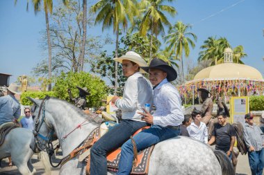 Villa de Alvarez, Colima, Mexico. February 11, 2023. Group of people on horseback in the horse parade for the charro bullfighting festivities in the city of Villa de Alvarez.