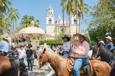 Villa de Alvarez, Colima, Mexico. February 11, 2023. Group of people on horseback in the horse parade for the charro bullfighting festivities in the city of Villa de Alvarez.