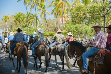 Villa de Alvarez, Colima, Mexico. February 11, 2023. Group of people on horseback in the horse parade for the charro bullfighting festivities in the city of Villa de Alvarez.