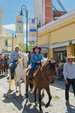 Colima, Colima, Mexico. February 11, 2023. Girl riding a horse in the horseback riding for the charro bullfighting festivities in the city of Villa de Alvarez.