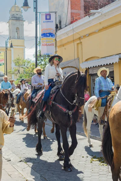 Colima, Colima, Mexico. February 11, 2023. Woman riding a horse in the horseback riding for the charro bullfighting festivities in the city of Villa de Alvarez.