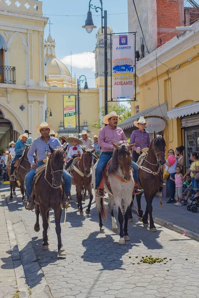Colima, Colima, Mexico. February 11, 2023. Group of people on horseback in the horse parade for the charro bullfighting festivities in the city of Villa de Alvarez.
