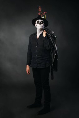 Deri ceket giyen, kedi makyajlı bir adam. Stüdyo portresi, Ölüler Günü.