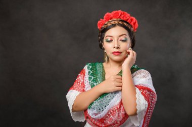 Portrait of beauty mexican woman with makeup with the colors of the Mexican flag.