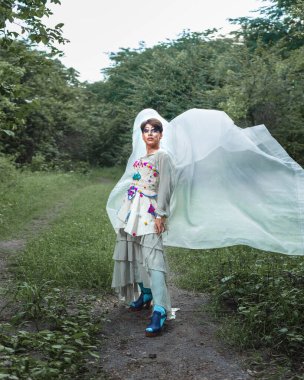 Kırsal alanda bir travestinin portresi. İkili cinsiyet içermeyen birinin portresi doğayla etkileşim halinde..