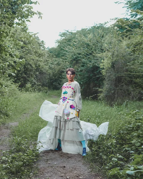 stock image Portrait of a drag queen in a rural scenery. Portrait of a non-binary gender person interacting with nature.