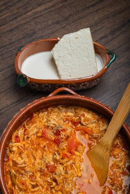 Otantik Meksika tavuğu tinga, tipik bir Meksika yemeği. Tahta masadaki kil çömlekte hazırlanır..