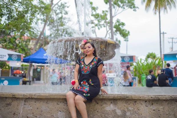 Mexican woman wearing traditional dress with multicolored embroidery. Woman celebrating the Cinco de Mayo.