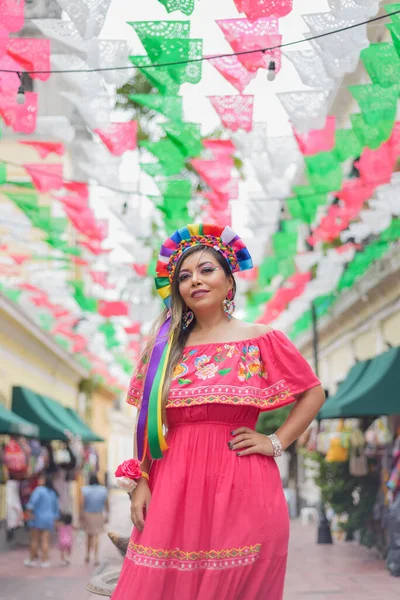 Mexican woman wearing traditional dress with multicolored embroidery. Woman celebrating the Cinco de Mayo.