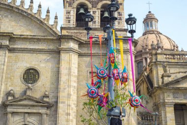Guadalajara, Jalisco. Meksika mı? 24 Aralık 2023. Guadalajara, Jalisco. Meksika mı? 24 Aralık 2023. Guadalajara 'daki Metropolitan Katedrali' nin önündeki aydınlıkta asılı renkli pinatalar..