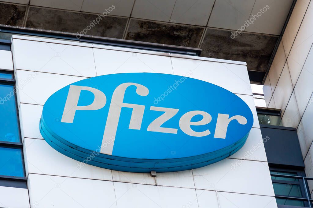 Montrouge, France - November 18, 2022: Logo sign on top of the building housing the headquarters of Pfizer France. Pfizer is an American pharmaceutical company present all over the world