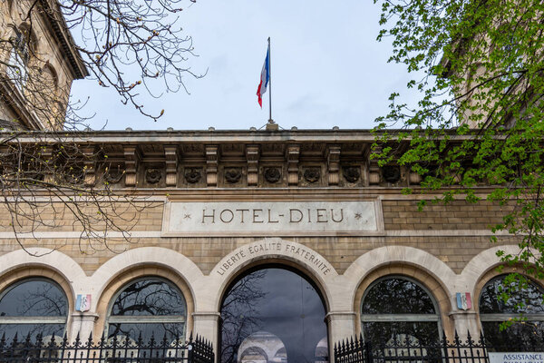 Paris, France - March 23, 2023: Exterior view of the Hotel-Dieu de Paris, a hospital belonging to the Assistance Publique - Hpitaux de Paris (AP-HP) located on the edge of the Notre-Dame parvis