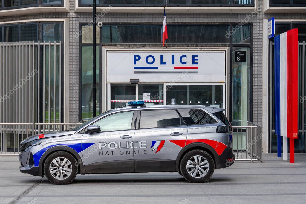 Puteaux, France - October 9, 2023: French national police patrol vehicle parked in front of the entrance to the police station in the Paris La Defense district