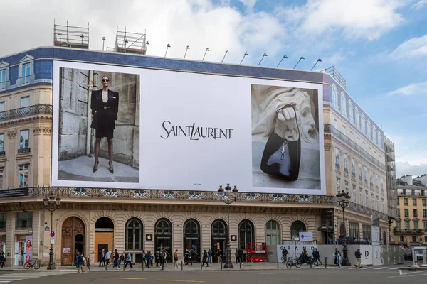 stock image Paris, France - October 31, 2023: Yves Saint Laurent giant advertising billboard covering the scaffoldings of the restoration works on the facade of a parisian building