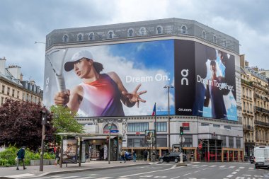 Paris, Fransa - 13 Mayıs 2024: Paris 'teki bir binanın restorasyon çalışmalarını kapsayan reklam panoları. Spor kıyafetleri ve ayakkabılar konusunda uzmanlaşmış bir İsviçreli şirket var.