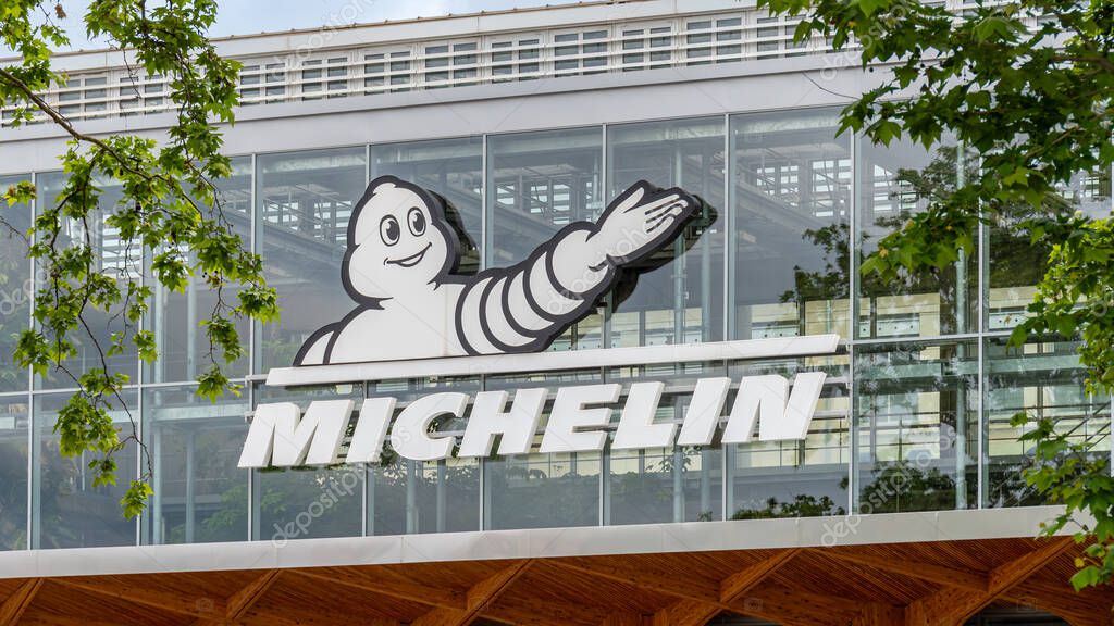 Clermont-Ferrand, France - May 23, 2024: Sign and logo on the Michelin headquarters building. Michelin is a French multinational company and one of the world leaders in tire manufacturing