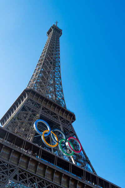 Paris, France - June 7, 2024: Olympic rings on the Eiffel Tower, famous monument symbol of Paris, city hosting and organizing the sports competitions of the Summer Olympic Games in 2024