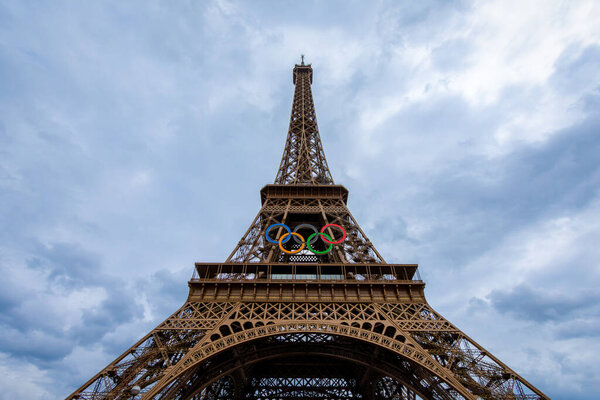Paris, France - July 3, 2024: The Eiffel Tower, symbol monument of the city of Paris, decorated with the Olympic rings on the occasion of the Paris 2024 Summer Olympics
