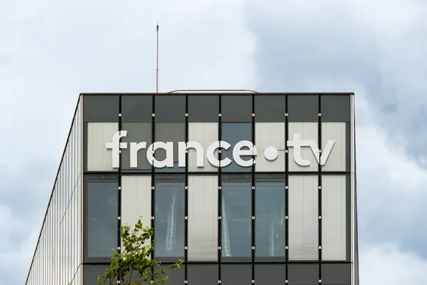 stock image Paris, France - July 3, 2024: Sign on the facade of a building of France Tlvisions, a French national company that manages public television stations activities in France