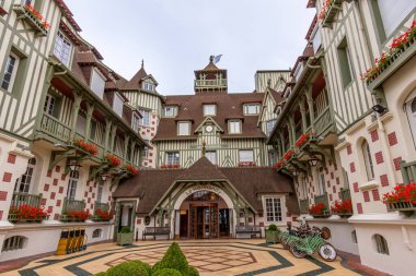 Deauville, France - July 21, 2024: Entrance to the Le Normandy Barriere hotel in Deauville. The Normandy is a large palace hotel built in traditional Norman style architecture clipart