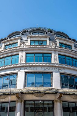 Paris, France - August 22, 2024: Facade of a Bon Marche building. Le Bon Marche, formerly called 'Au Bon Marche', is a French department store located in the 7th arrondissement of Paris clipart