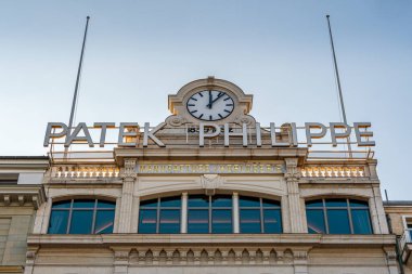 Geneva, Switzerland - November 15, 2024: Commercial sign at the top of the building hosting the Patek Philippe salons in Geneva. Patek Philippe is a Swiss luxury watchmaking company clipart