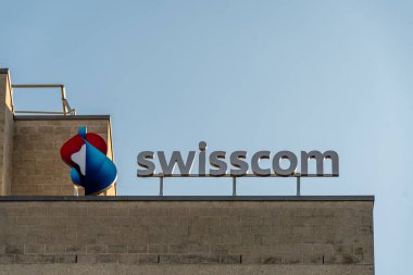 Geneva, Switzerland - November 16, 2024: Sign and logo on a Swisscom telecommunications center. Swisscom AG is a public company and one of the leading Swiss telecommunications providers clipart