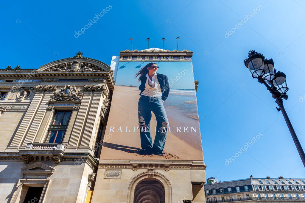 Paris, France - April 9, 2025: Large advertising billboard for Ralph Lauren covering the scaffoldings of the restoration works on the side facade of the Paris Opera house (Palais Garnier)