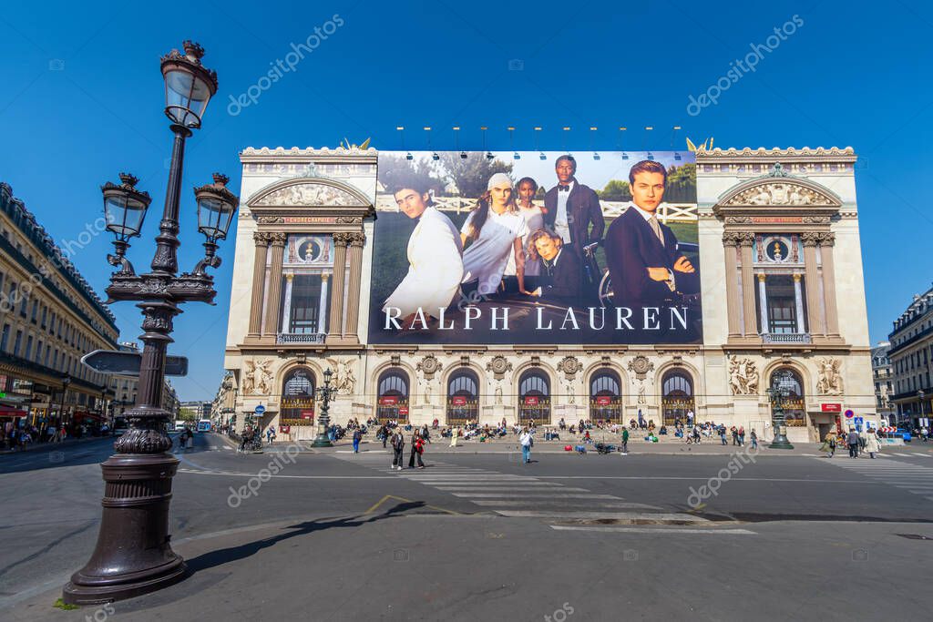 Paris, France - April 9, 2025: Giant advertising billboard for Ralph Lauren covering the scaffoldings of the restoration works on the main facade of the Paris Opera house (Palais Garnier)