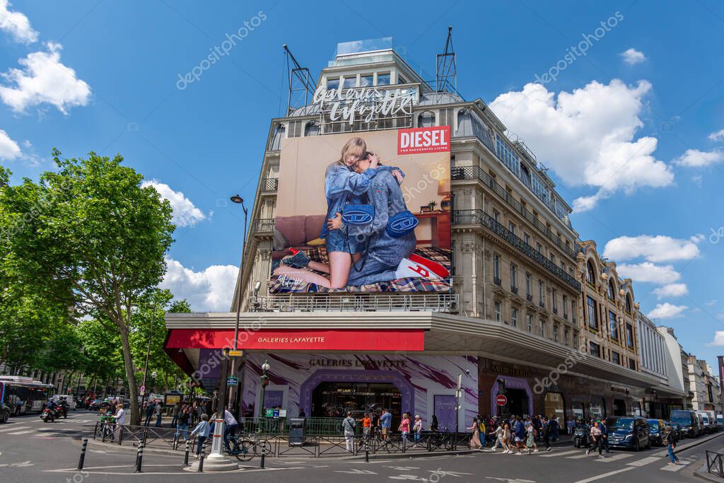 Paris, France - May 14, 2025: Large advertising billboard for Diesel, an Italian fashion brand, covering the facade of the Galeries Lafayette, a famous department store of Paris, France