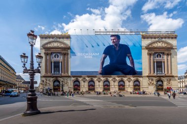 Paris, Fransa - 16 Haziran 2025: Beckham için reklam panosu - Hugo Boss tarafından yapılan Patron giyim koleksiyonu, Paris Opera binasının ön cephesindeki restorasyon çalışmaları (Palais Garnier)