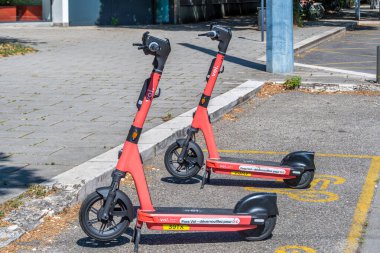Grenoble, Fransa - 5 Temmuz 2025: Grenoble, Fransa 'da bir sokağa park edilmiş iki adet pembe Voi scooter. VOI Technology AB İsveçli bir firma ve elektrikli scooter ve bisiklet paylaşım operatörüdür.