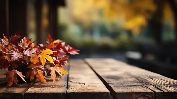 Autumn border from apples, pumpkin and fallen leaves on old wooden table. Halloween or Thanksgiving day concept.