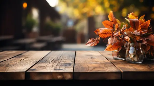 Autumn border from apples, pumpkin and fallen leaves on old wooden table. Halloween or Thanksgiving day concept.