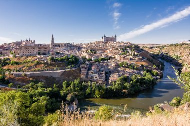 Skyline of the old city of Toledo on the hill where the Old Cathedral and the Alcazar stand embraced by the Tagus River