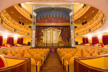 Almagro, Spain - 23 June 2022: Interior with stage and stalls of the Municipal Theater of Almagro without people clipart