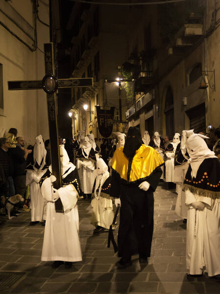 Кьети, Италия - 29 марта 2024 года: Верующие в капюшоне несут в себе символы страсти Христа во время шествия в старейшей процессии в Италии